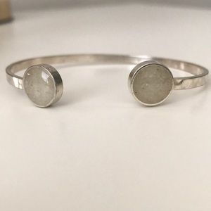 Hammered silver cuff bracelet with stone detail.
